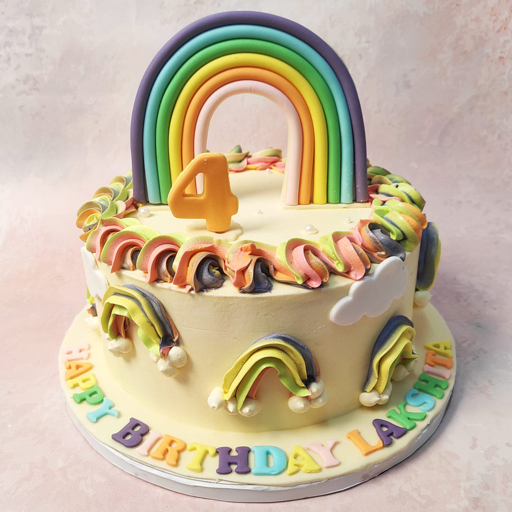 At the heart of this Buttercream Rainbow Cake lies a radiant rainbow arching gracefully across the top tier. 