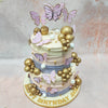 Gold baubles are scattered across this  pastel butterfly cake like stars across the evening sky, 