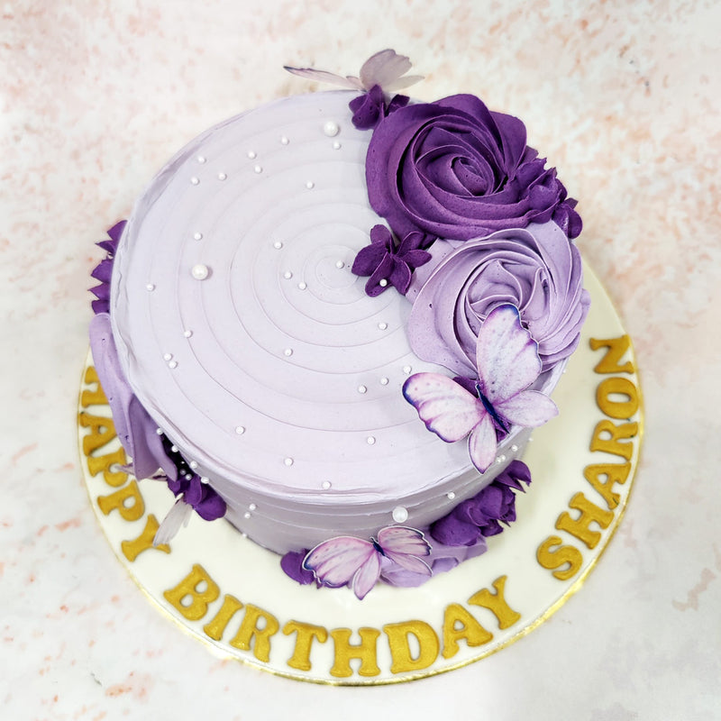 The delicate lavender base creates a dreamy canvas for intricate detailing, with gentle horizontal texturing providing subtle dimension to this Butterfly Pearl Cake.