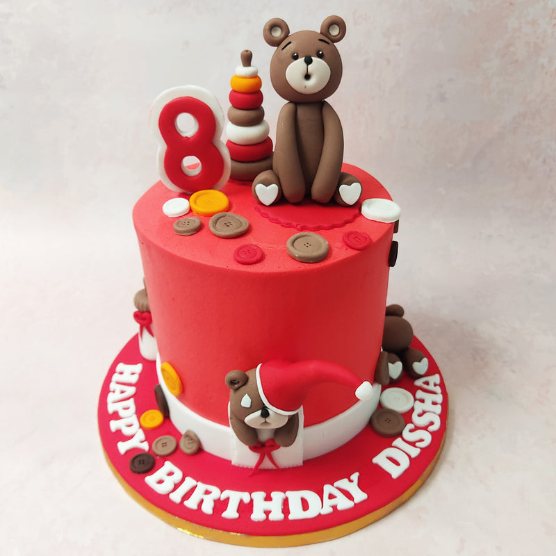 Scattered throughout this Button Cake are playful buttons, adding to the whimsical feel of this toy-themed creation.