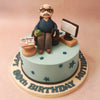 Seated on a black leather chair, holding a cup of chai in one hand, is the star of this birthday cake for grandfather: the figurine of your Dadaji, customised according to his look and attire to make him feel even more like the star of the show.