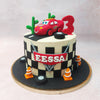 The chequered pattern adorning the base of this McQueen Car Cake adds a touch of speedway excitement, while edible traffic cones and tires line the bottom tier, ready to guide racers to victory. 