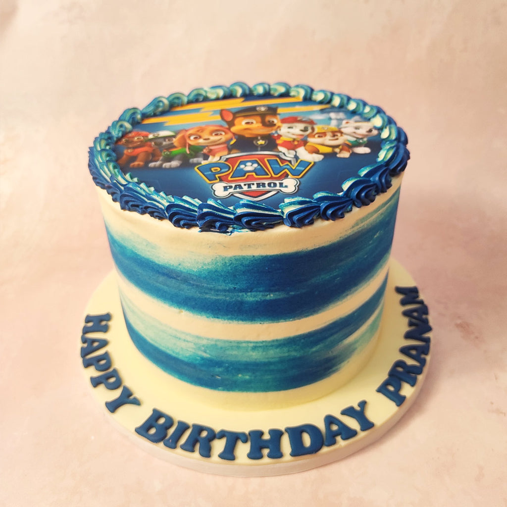 With its tall blue and white ombre base, reminiscent of the vast sky, and a buttercream swirl border that adds a playful touch, this Blue Paw Patrol Cake is a true masterpiece. 