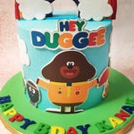 The colourful "Hey Duggee" logo adds a pop of fun and familiarity to this Cartoon Theme Cake, making it an instant hit at any gathering.