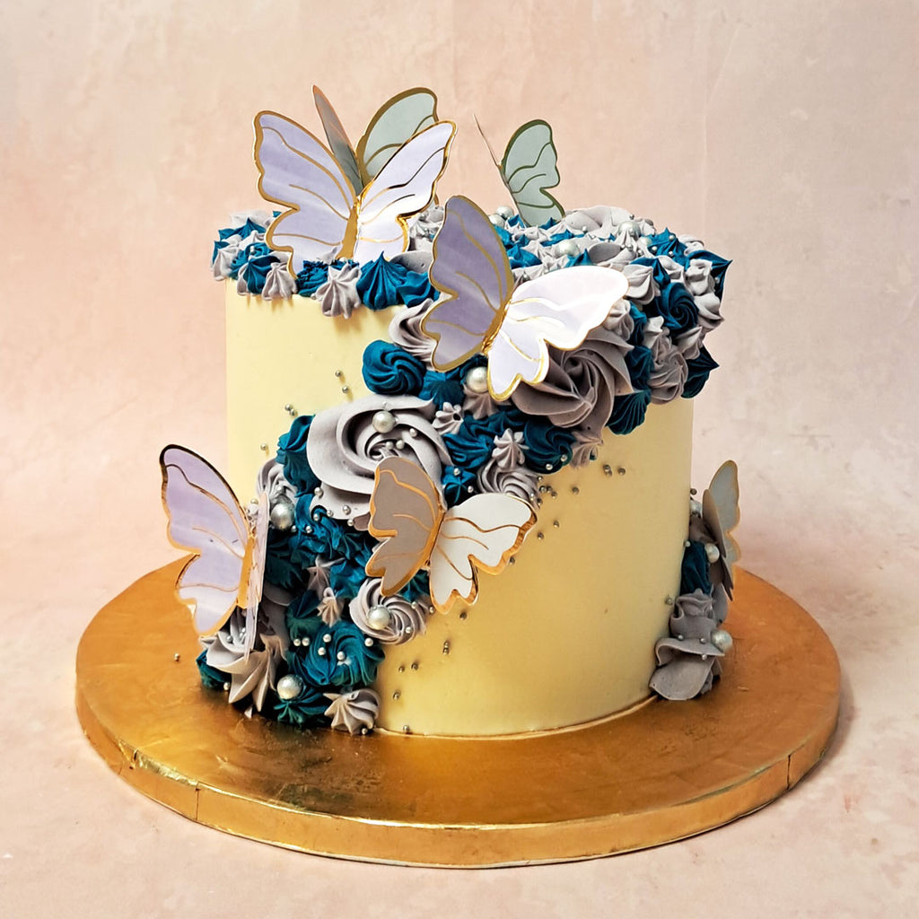 To further enhance the design of this floral butterfly cake., it is embellished with edible pearls and 3D purple and gold butterflies 