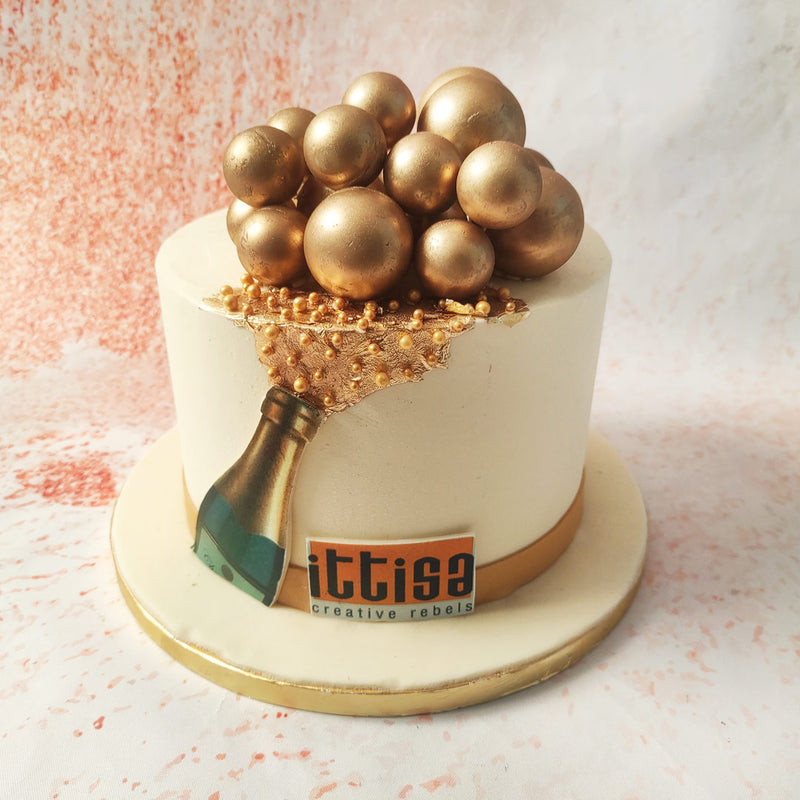 The design of this Champagne Bubbles Cake cleverly integrates a champagne bottle at the base, with the golden bubbles seemingly spilling out, capturing the essence of celebration and joy.