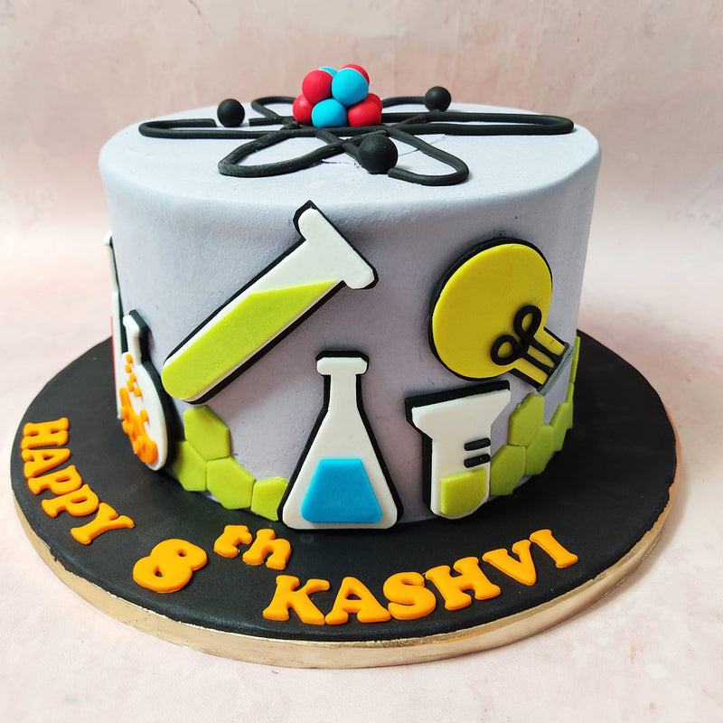 At the zenith of this Science Cake, the atomic structure takes centre stage, symbolising the nucleus of scientific brilliance.