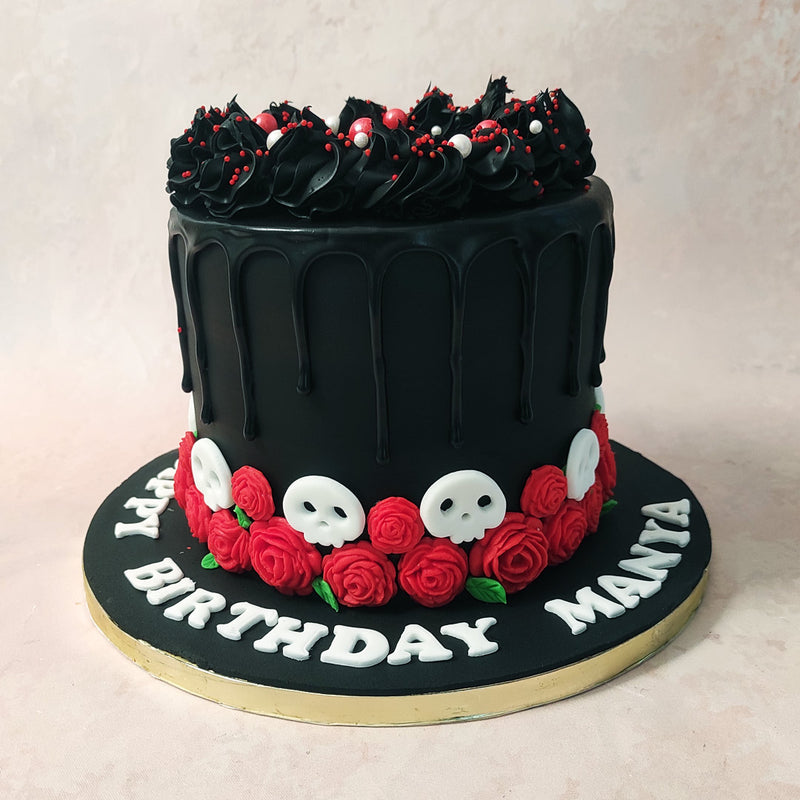 Featuring a tall, matte, chocolate base with glistening and gleaming chocolate frosting aesthetically dripping down the sides, this skull and roses cake is the picture of sugar-coating the dark side. 