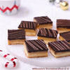 Pack of four Millionaire's Shortbread with chocolate on a white surface.