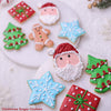 Collection of Christmas-themed sugar cookies on a white surface.