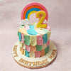 Colourful pastel buttercream smudges adorn the top tier and vibrant scales cover this Rainbow and Cloud Cake design. 