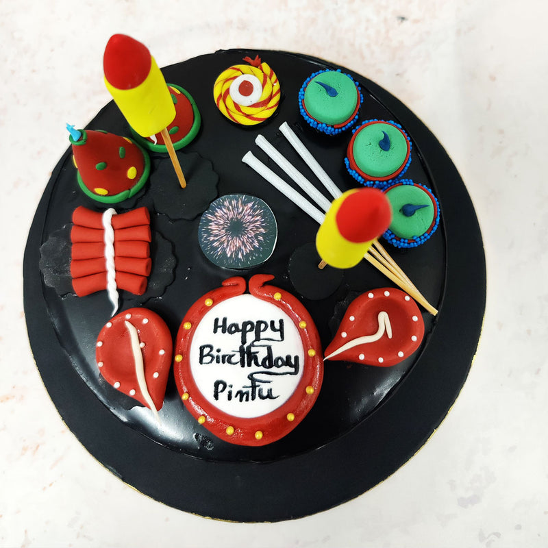 The sleek black backdrop of this Cracker Cake sets the stage for a bold and striking design, making the colourful decorations pop with energy. 