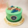 This delightful Cricket Birthday Cake For Dad features a vivid green base, symbolising the lush cricket pitch, adorned with meticulously detailed fondant decorations that bring the essence of the game to life. 