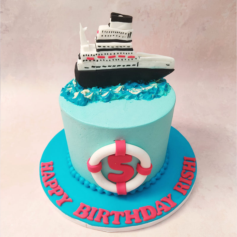At the centre of this Sailing Cake stands a magnificent black and white cruise ship, complete with intricate details that capture the essence of maritime travel. 