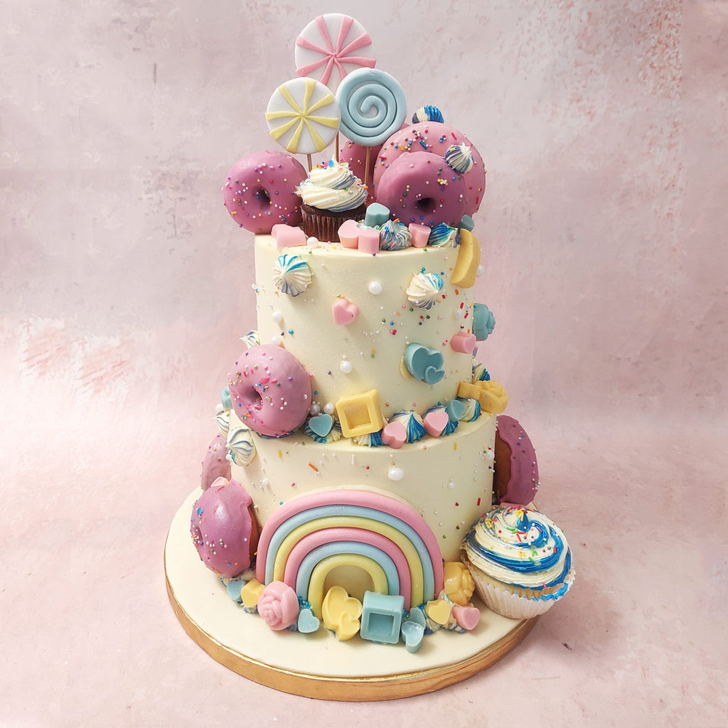 This Cupcake Donut Cake is transformed into a riot of colour with pastel shapes and candy blocks, sprinkles and edible pearls. 