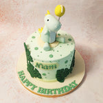 This Dino and Balloon Cake is decorated with dark green to white ombre dots, creating a playful yet elegant background. 