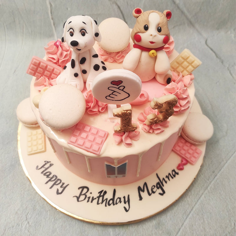 On top of the BTS design cake, you'll find miniature figurines of a dalmatian and a blushing hamster, representing some of the band's beloved mascots. 