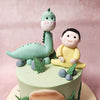 Adorning this Arlo The Good Dinosaur Cake are edible leaves and rocks, meticulously crafted with the finest ingredients. 