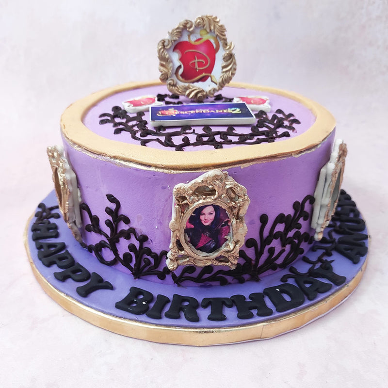 This Descendants birthday cake for kids features a magical purple base with intricate black buttercream vines ornamenting it. A framed picture of all four descendents: Carlos, Jay, Evie and Mal embellished the circumference of this Disney theme cake design. 