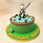 The donkey, with its endearing expression and playful pose, holding a pool cue, adds a humorous and light-hearted touch to this Birthday Cake For Kids. 