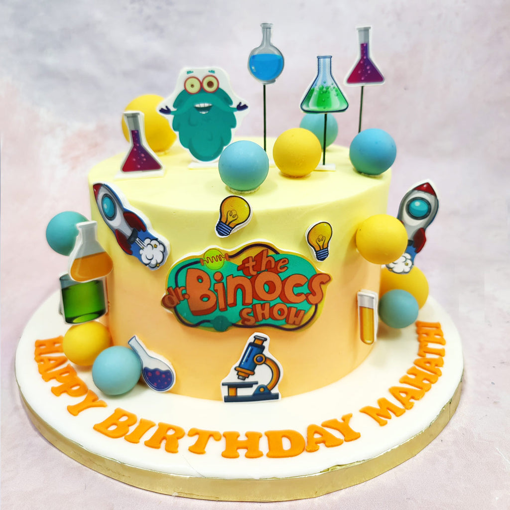 This Dr. Binocs Cake is a quirky explosion of colour, curiosity, and all things science, perfect for the inquisitive little mind who wants answers to everything. 