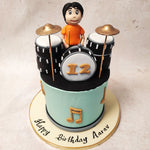 This drum cake is designed to captivate young music enthusiasts with its vibrant colours and playful symbolism. With a light blue base adorned with gold musical notes, it sets the stage for an unforgettable birthday experience.