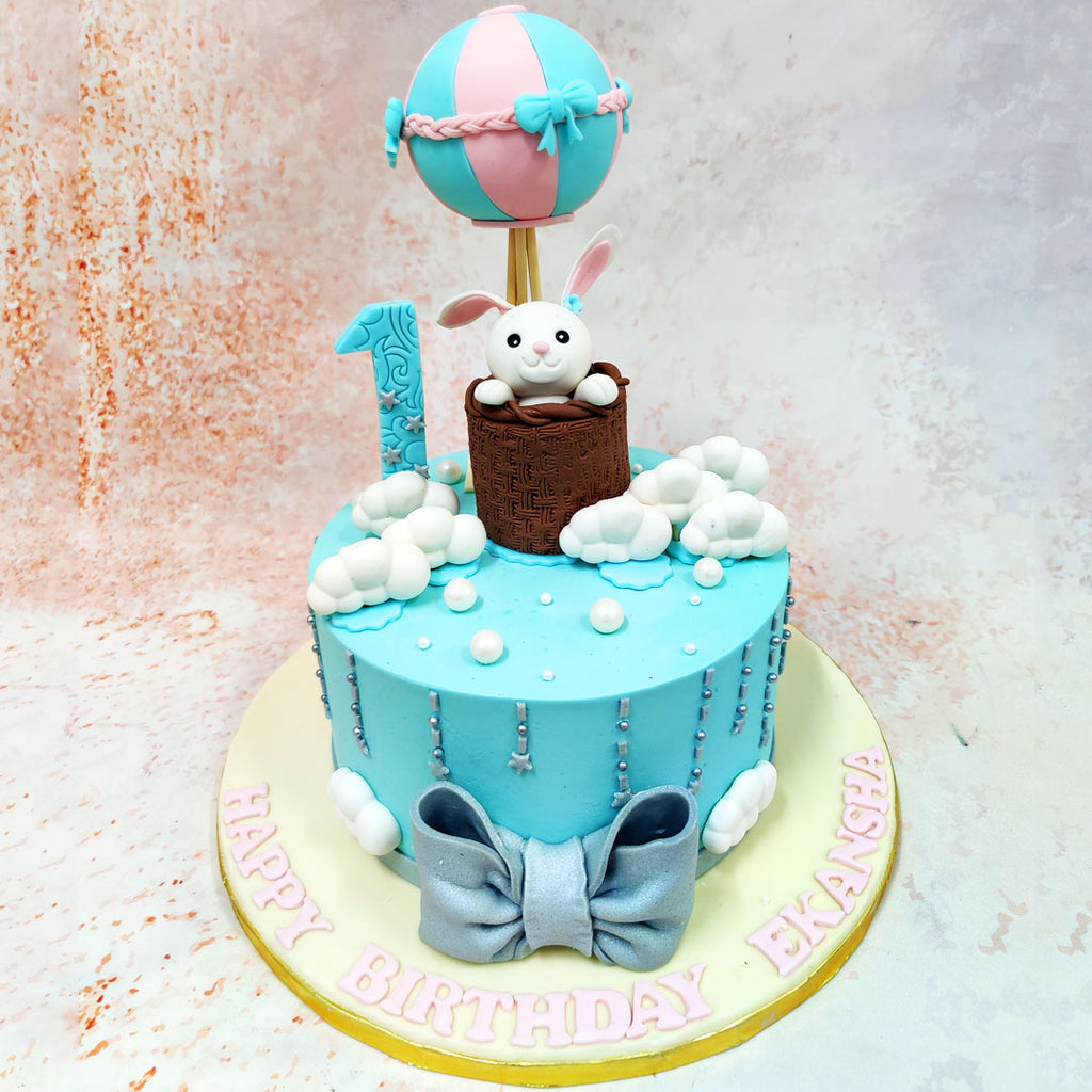 This Easter Bunny Basket Cake brings to life a whimsical first birthday celebration with an enchanting hot air balloon theme. 