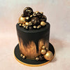 The smooth black tones covering this black and gold birthday cake for wife serve as a canvas for the intricate golden details that adorn its surface.