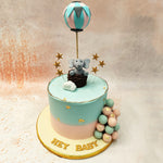 At the top of this Elephant Baby Shower Cake, a pastel hot air balloon soars, symbolising dreams and adventures, while a cute little elephant sits in a basket, embodying innocence and joy. 