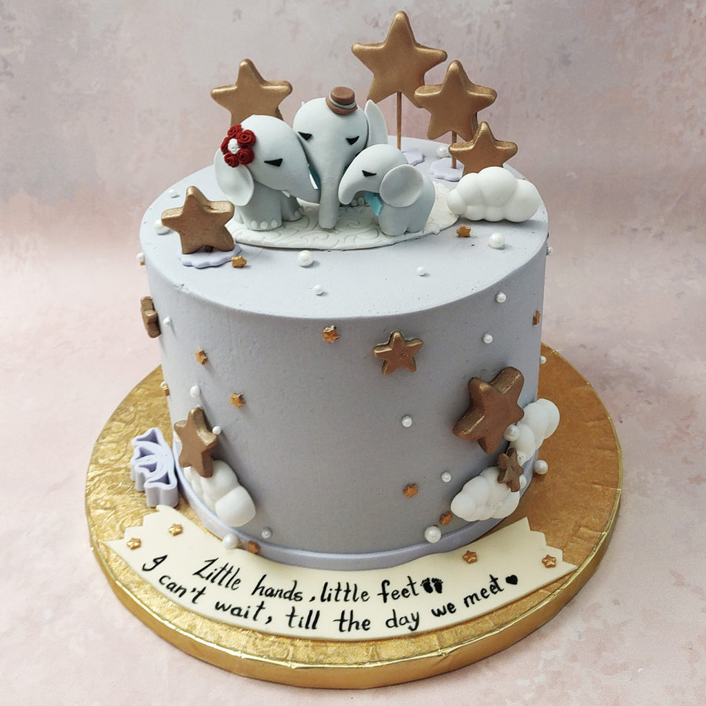 The gentle, pastel blue hue of this birthday cake for kids design can be spotted all over this piece, embellished with golden stars and fluffy white clouds all over, adding a celestial element to the aesthetic. 