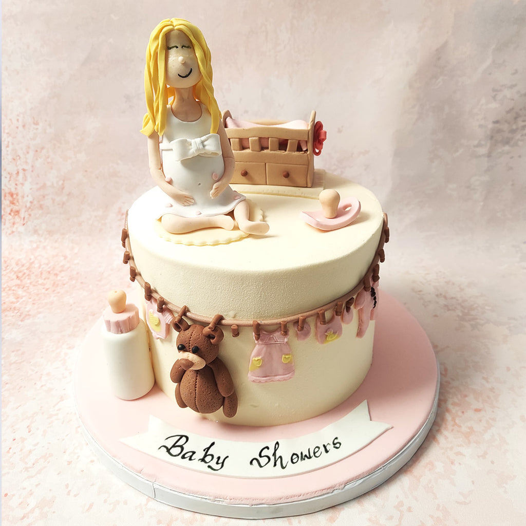 With a creamy base as soft as a mother's touch, adorned with baby items, this Expecting Cake weaves a tale of tender moments to come. 