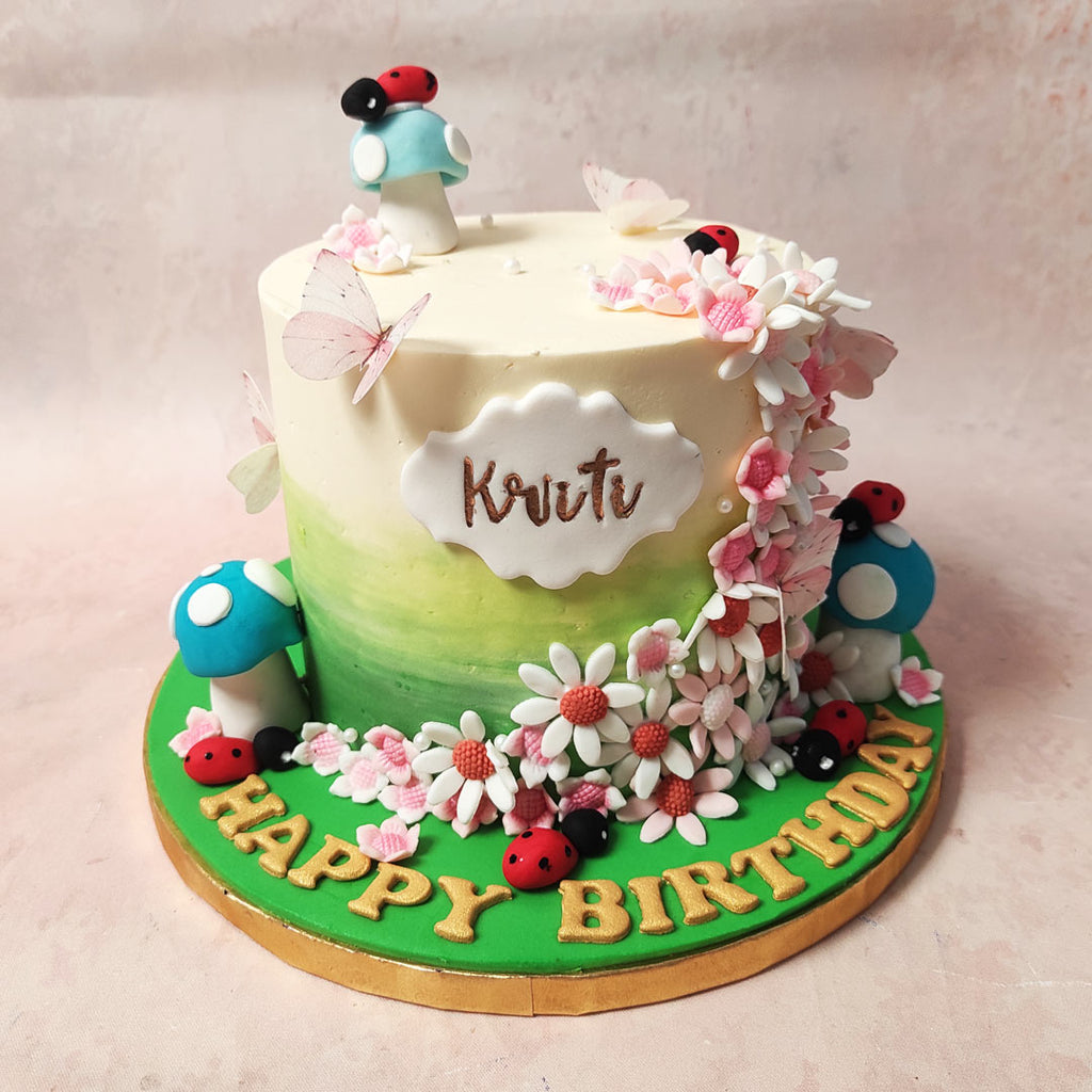 The base of this woodland cake is a captivating blend of lush green at the bottom, gently transitioning to pure white at the top, reminiscent of a mystical forest clearing dappled in sunlight.