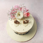 Atop this  Family Silhouette Cake, delicate pink and white roses, along with sprigs of baby's breath, create a charming floral arrangement that exudes warmth and affection.