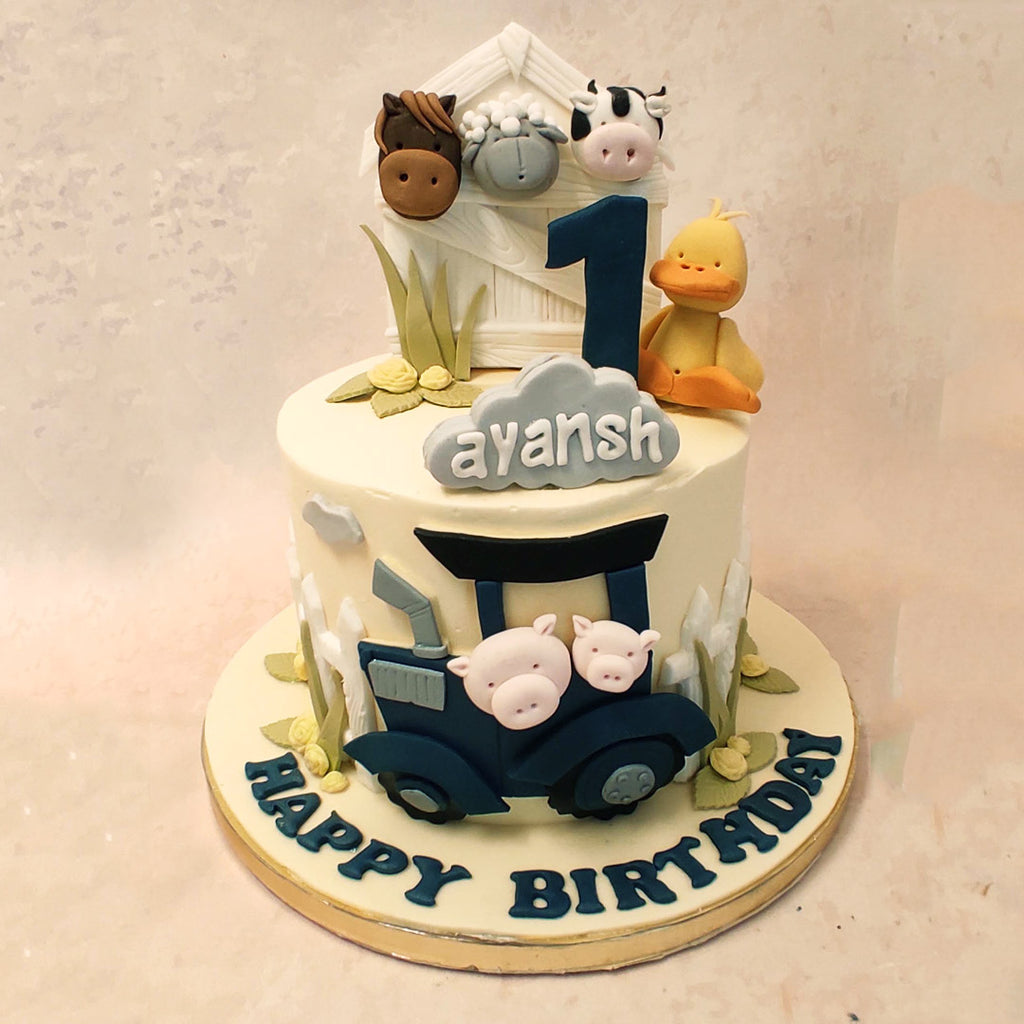 On the outskirts of this edible farm themed birthday cake for kids, a blue tractor can be seen chugging along. Inside are two mischievous little pigs, ready for an adventure. 