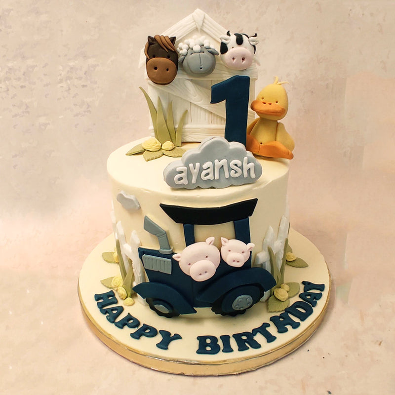 On the outskirts of this edible farm themed birthday cake for kids, a blue tractor can be seen chugging along. Inside are two mischievous little pigs, ready for an adventure. 