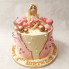 This original fairy cake design features a pretty fairy figurine sitting cross-legged on top, dressed in a charming pink gown. 