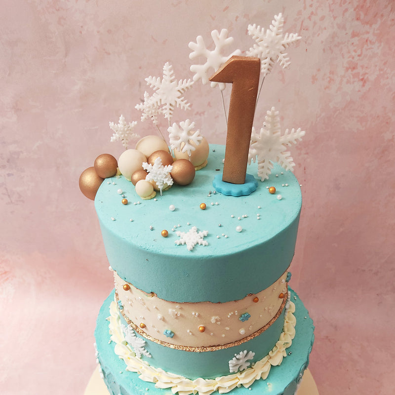 A fault line of snowy white, elegantly intersected by a golden border on top, each layer on this Winter Theme Cake adorned with intricate snowflake embellishments and glistening pearls.
