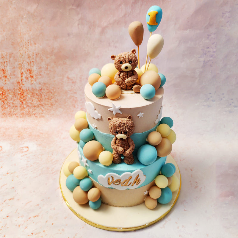 At the top of this Birthday Cake For Kids, a teddy bear holding balloons stands as a centrepiece, symbolising childhood innocence and the joy of celebrations. 