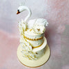 Subtle gold accents and pearls are scattered throughout, enhancing the Swan Theme Cake’s luxurious feel.