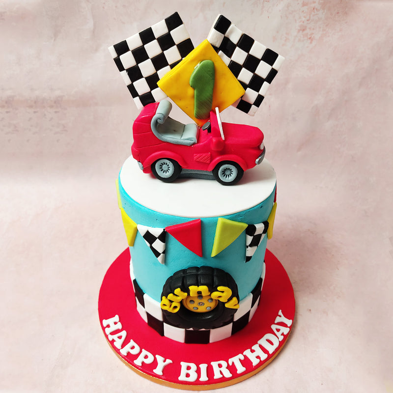 At the heart of the edible racetrack that is this Finish Line Cake is an iconic truck tyre figurine, holding the centre stage like a champion of the track. 
