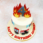 The design of this Fire Theme Cake showcases a meticulously detailed fire engine in classic red and white, complete with a realistic extending ladder and carefully crafted wheels. 