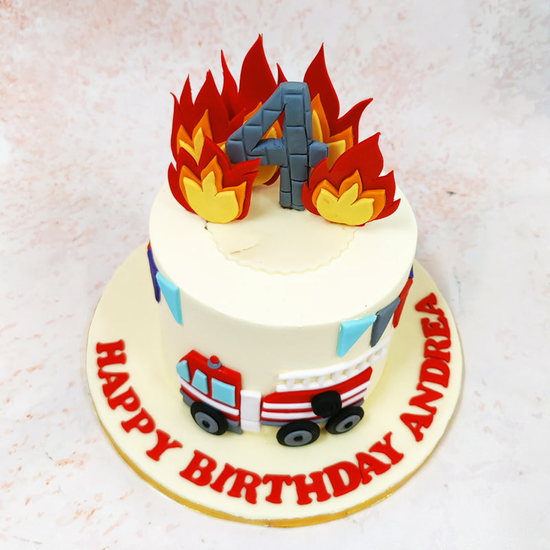 The design of this Fire Theme Cake showcases a meticulously detailed fire engine in classic red and white, complete with a realistic extending ladder and carefully crafted wheels. 