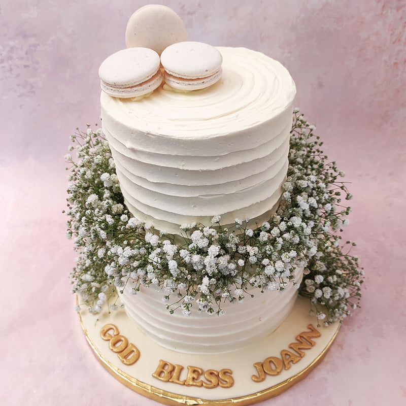 Embedded with an abundance of Baby's breath in between both tiers, this First Holy Communion cake comes filled with holy symbolisms