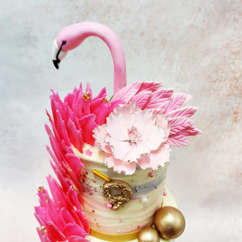 The head of the flamingo, a symbol of grace and balance, proudly sits atop this Flamingo Bird Cake, while its soft pink wings are beautifully represented by delicate sugar petals that cascade down one side. 