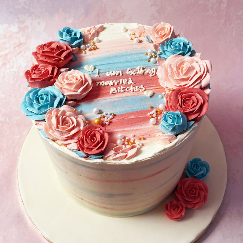 Standing tall with a pristine white base, this Ombre Bachelorette Cake boasts a breathtaking ombre cascade in hues of blue and pink, reminiscent of the vibrant energy of the occasion. 