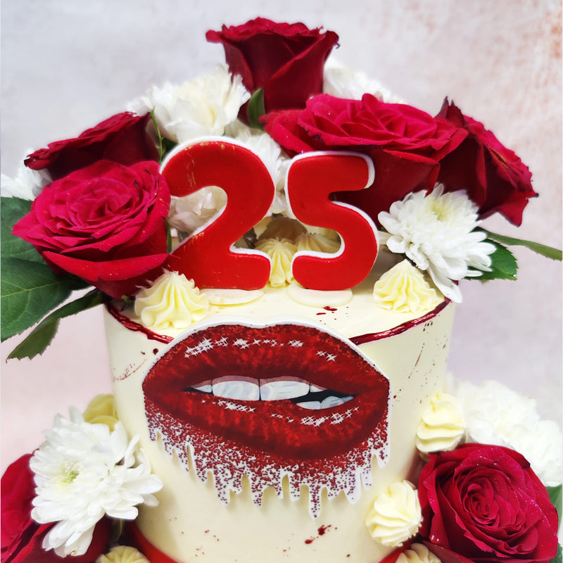 Surrounding the tiers of this Floral Kisses Cake are vivid red and white chrysanthemums , signifying love, beauty, and new beginning.