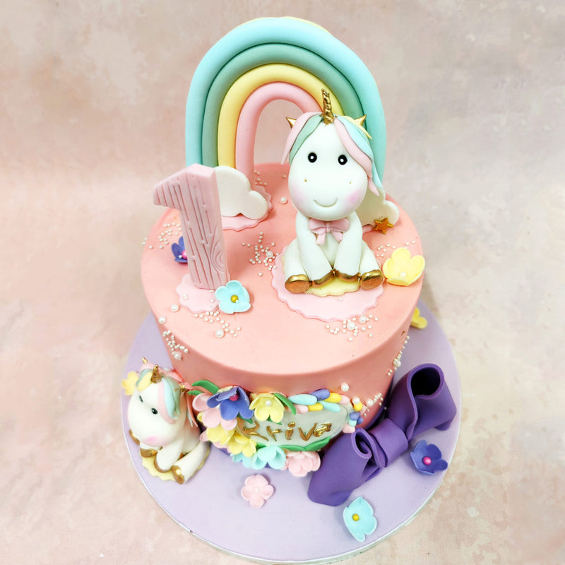 The handcrafted flower wreath on this Floral Unicorn Cake combines mint, lavender, and blush blooms, creating a fresh and feminine accent. 