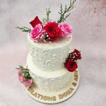 The patterns on this engagment cake with fresh flowers closely replicate the ones often seen on a bridal gown or veil. 