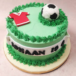 Visually creating the image of a grassy, football field, this sports theme cake sports a host of icons familiar to this passion such as a football of course and a red and white jersey, customisable to the colour of the recipient's preferences