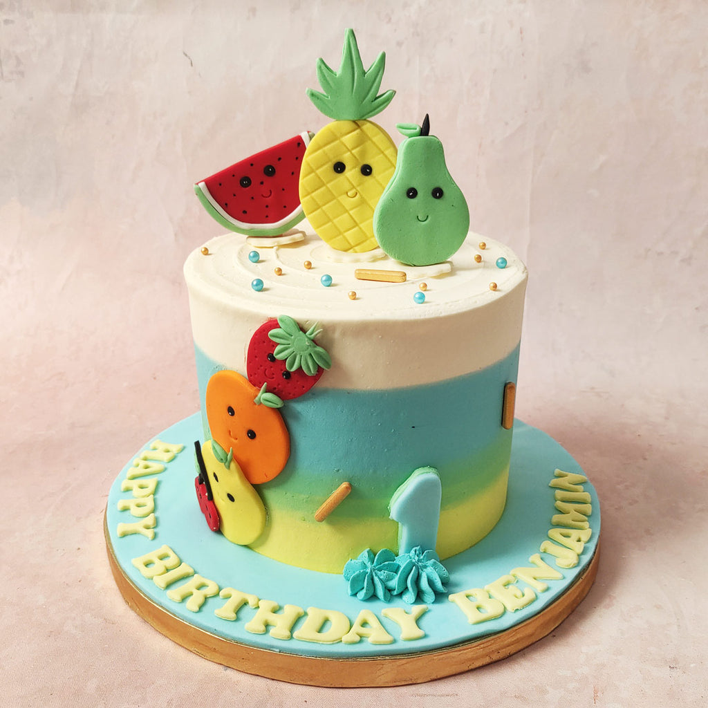 The base of this Fruits Theme Cake, transitioning from sunny yellow to juicy green, then to a berrylicious blue and finally to a heavenly white, is a mouthwatering ombre masterpiece.  Adorning this Smiley Fruit Cake are miniature fruit figurines, each sporting a cheeky smile like they just cracked the best fruit joke in town.   From stunning strawberries to peaky pears, they're here to turn your Pineapple Theme Cake into a fruity stand-up comedy show that will have your taste buds in stitches